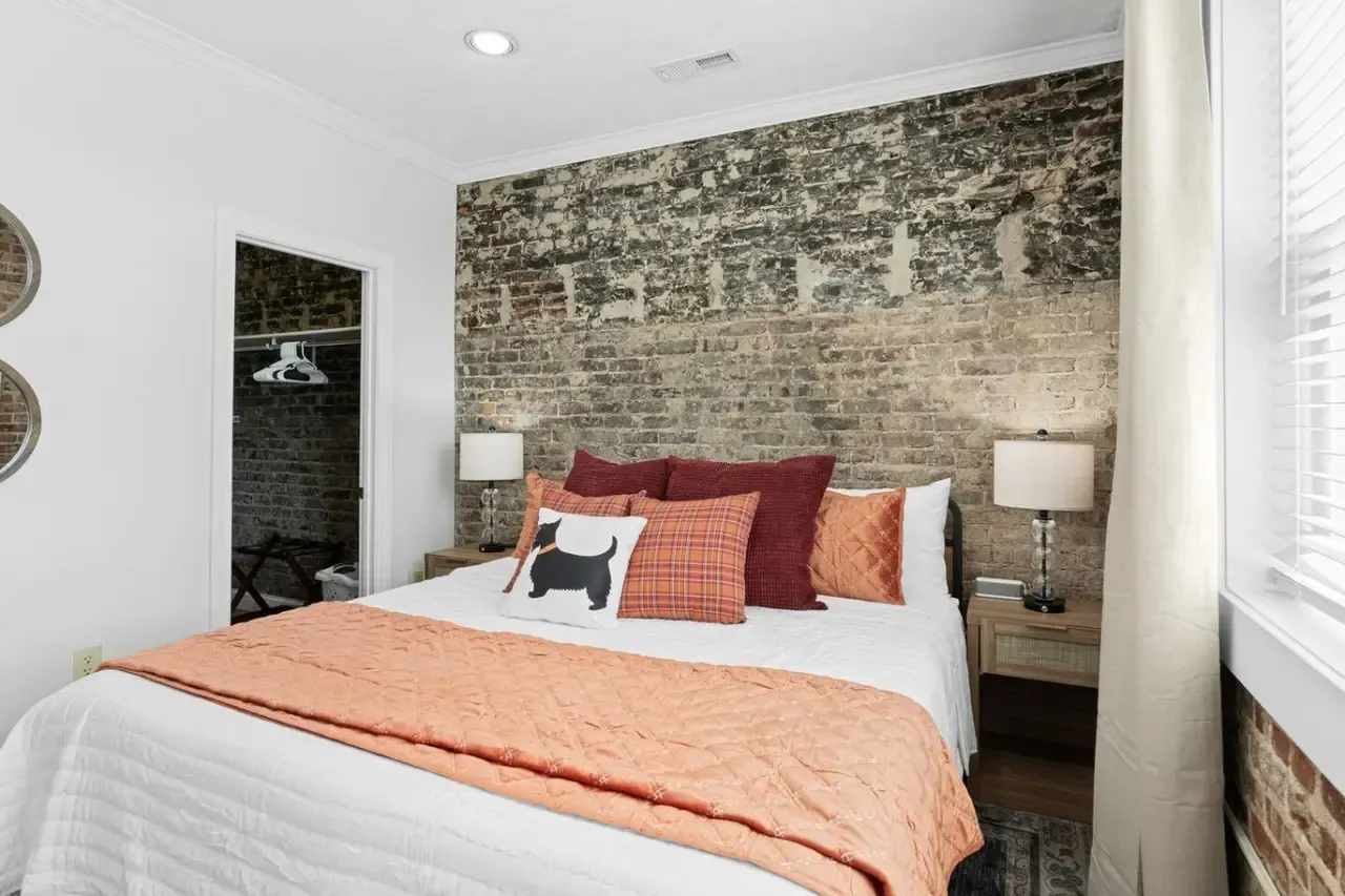 Bedroom with exposed brick in Scot’s Suite