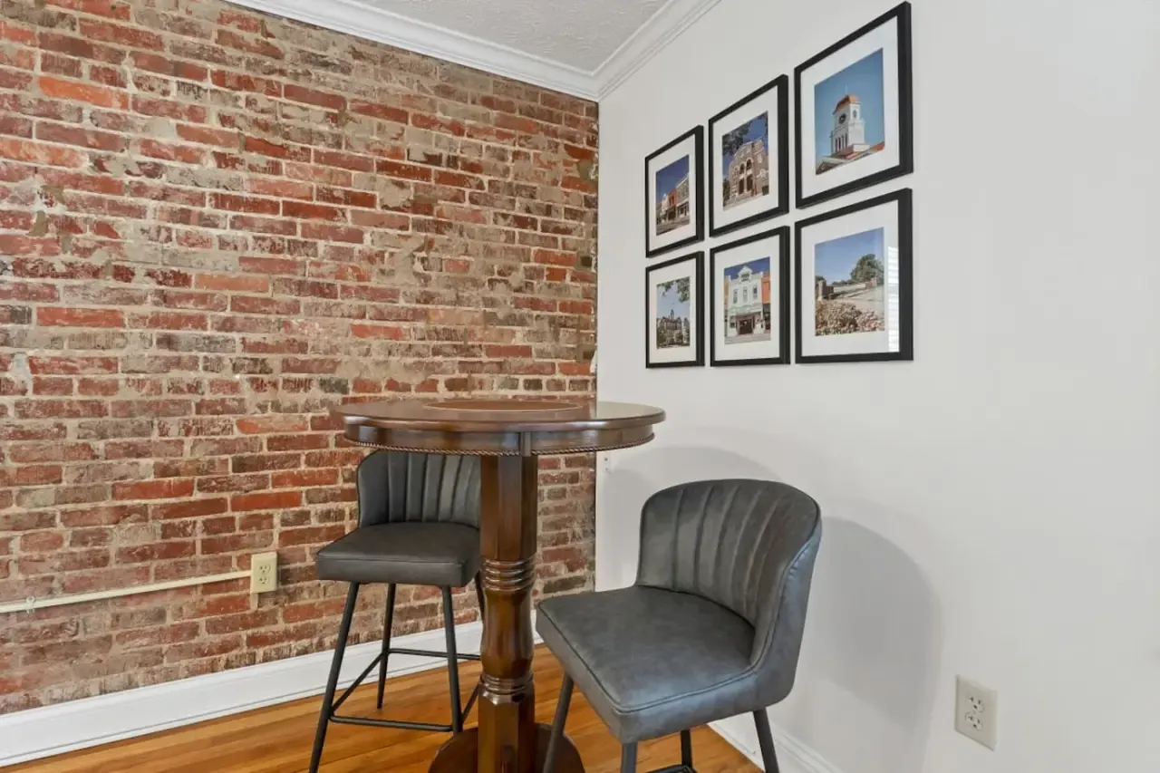 Dining nook beside the exposed-brick wall in Blue Bella