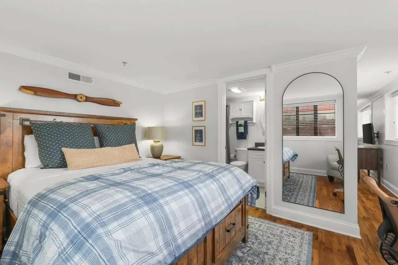 King bedroom with a wooden propeller above the bed at The Landing