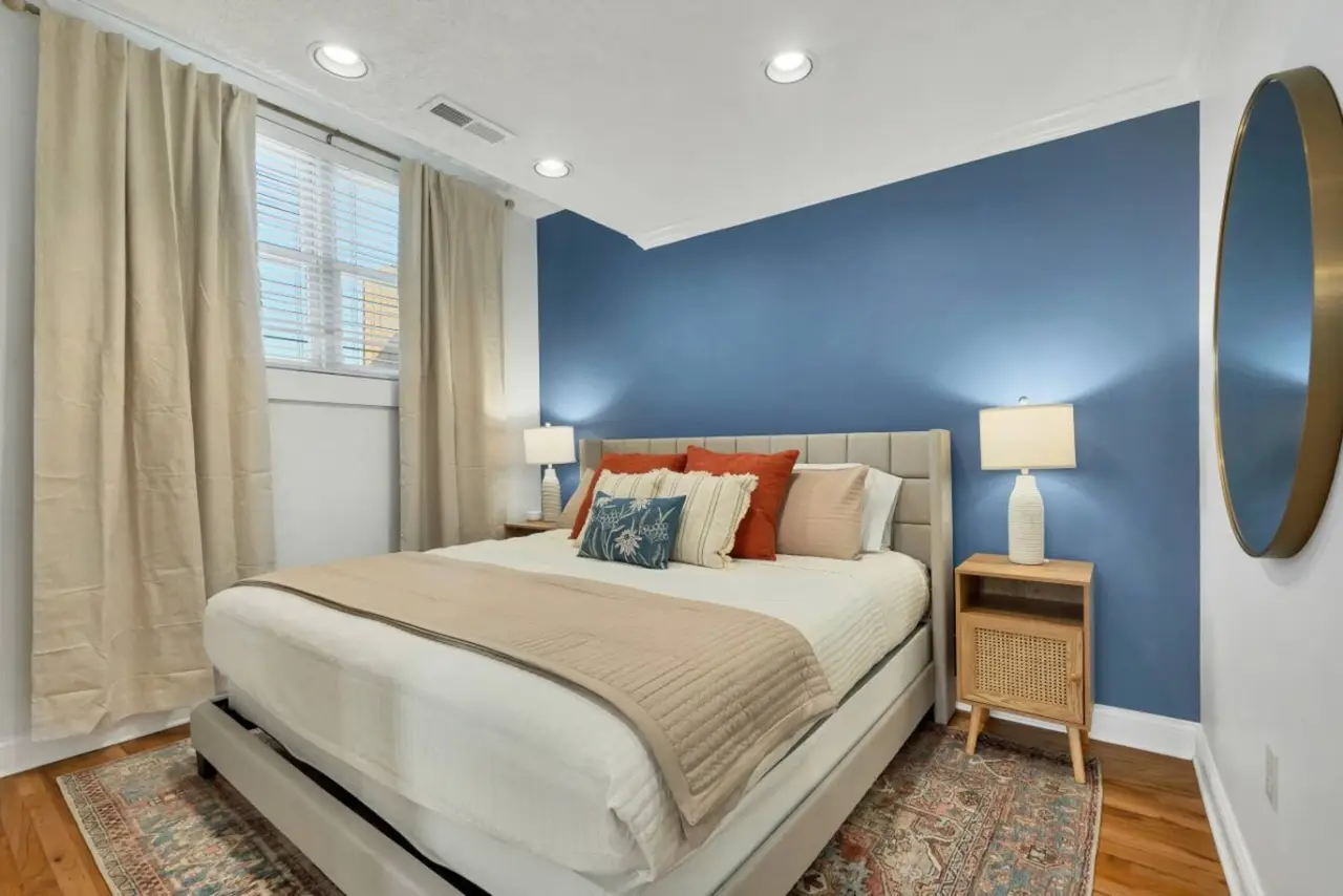 King bedroom with blue accent wall in Blue Bella